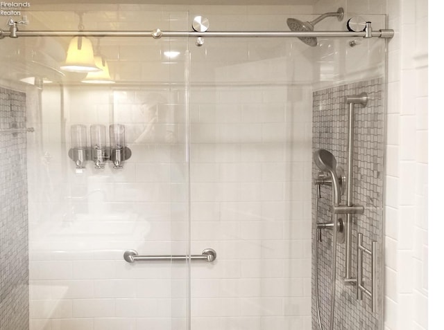 bathroom featuring a shower with shower door