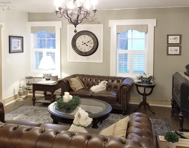 living room with wood-type flooring and a notable chandelier