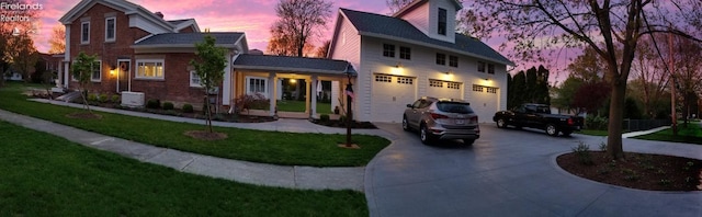 view of front of property featuring a yard, a garage, and central AC unit