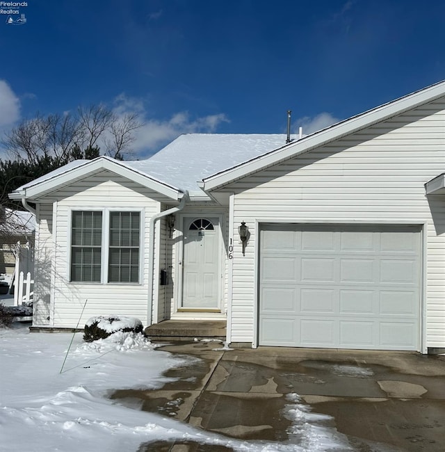 single story home featuring a garage and driveway