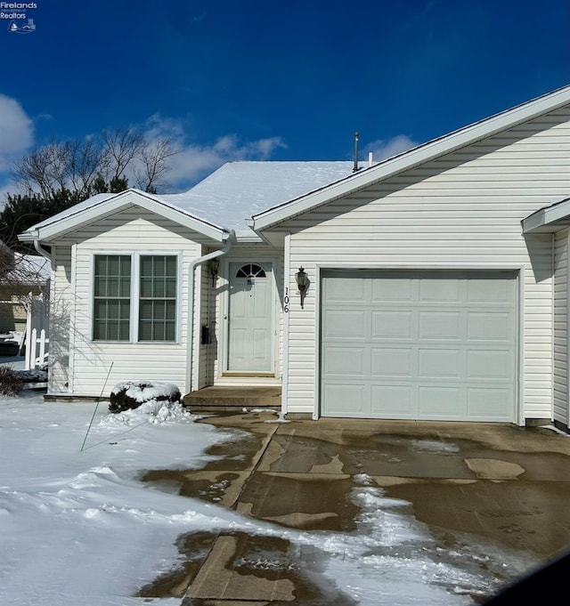 single story home featuring a garage and driveway