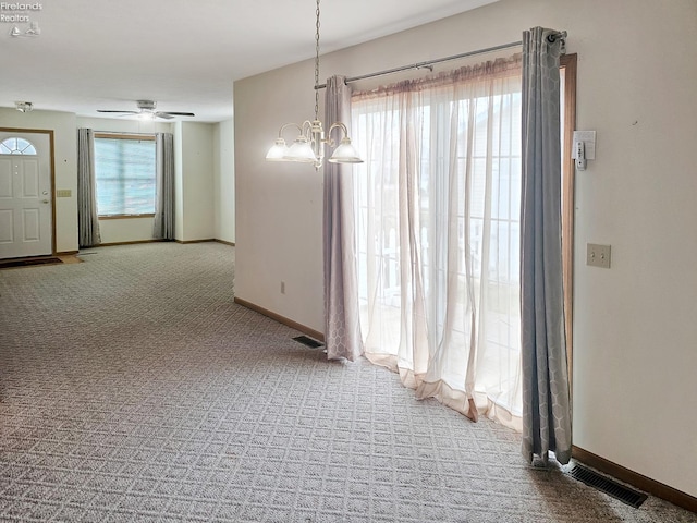 interior space with carpet, visible vents, and a healthy amount of sunlight