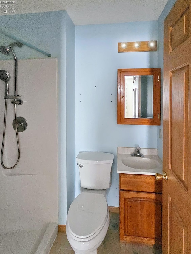 full bath with toilet, walk in shower, vanity, and baseboards