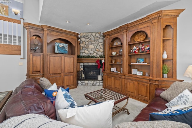 carpeted living room featuring a stone fireplace