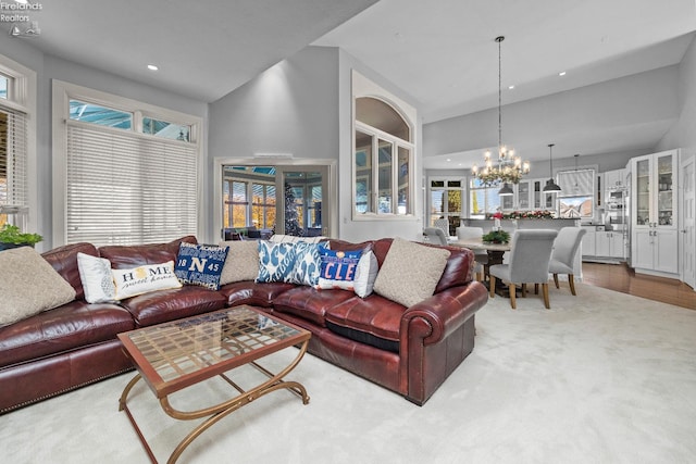 living room featuring an inviting chandelier and a towering ceiling