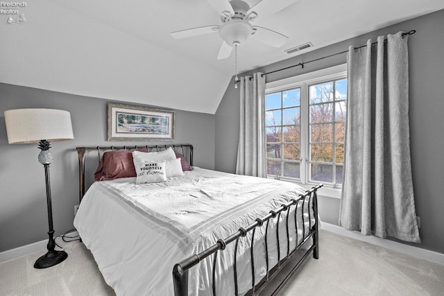 bedroom featuring ceiling fan, light colored carpet, and vaulted ceiling