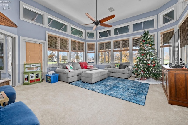 sunroom with a healthy amount of sunlight and ceiling fan