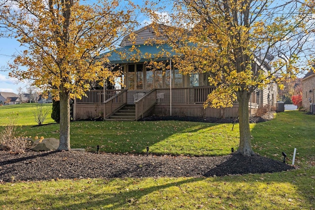 exterior space with a deck and a lawn