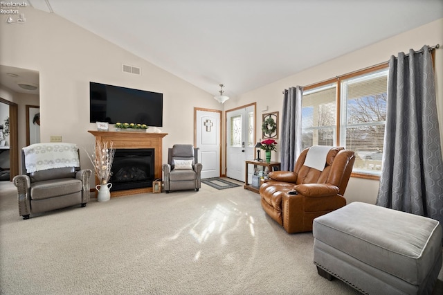 carpeted living room featuring high vaulted ceiling