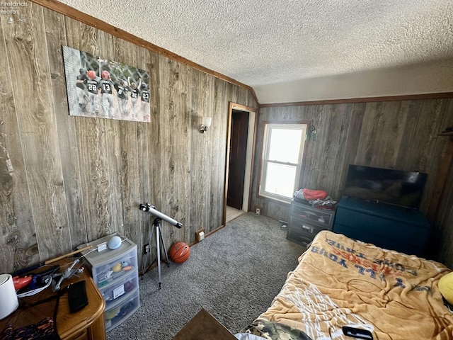 carpeted bedroom with a textured ceiling, lofted ceiling, and wooden walls