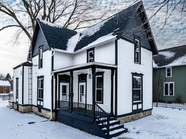 view of front of property featuring roof with shingles