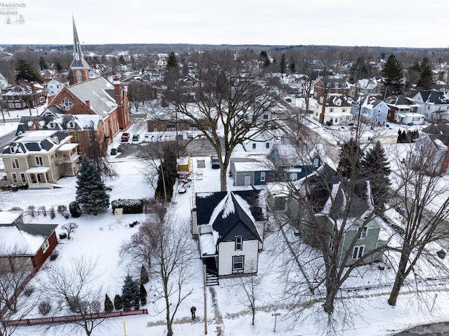 snowy aerial view with a residential view