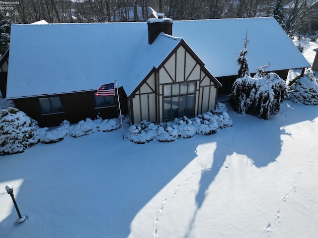 view of front of property with a garage and a chimney