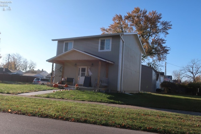 view of front of home featuring covered porch and a front lawn