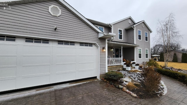 traditional-style home with a garage and covered porch