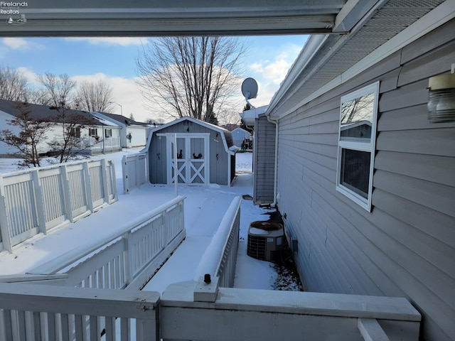 exterior space with a storage unit, central AC, and an outbuilding