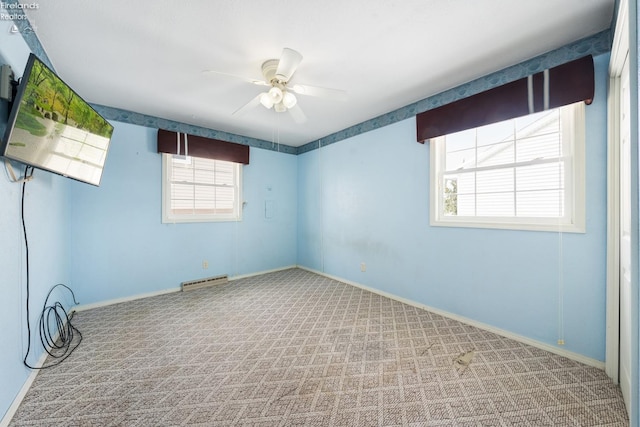 unfurnished room with visible vents, baseboards, a ceiling fan, and light colored carpet