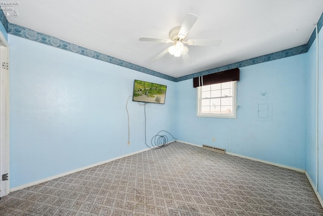 carpeted spare room featuring ceiling fan, visible vents, and baseboards