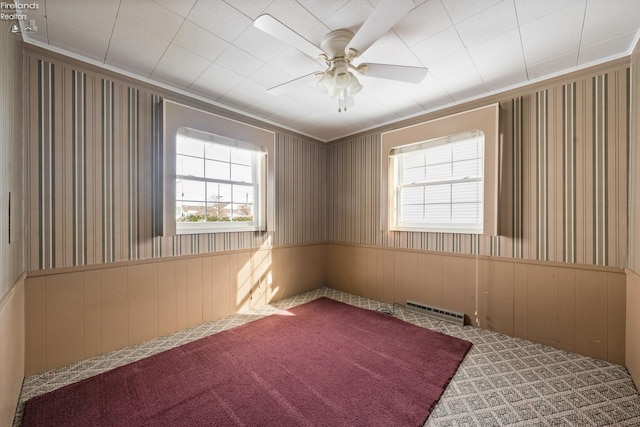 unfurnished room with wallpapered walls, visible vents, carpet flooring, and wainscoting