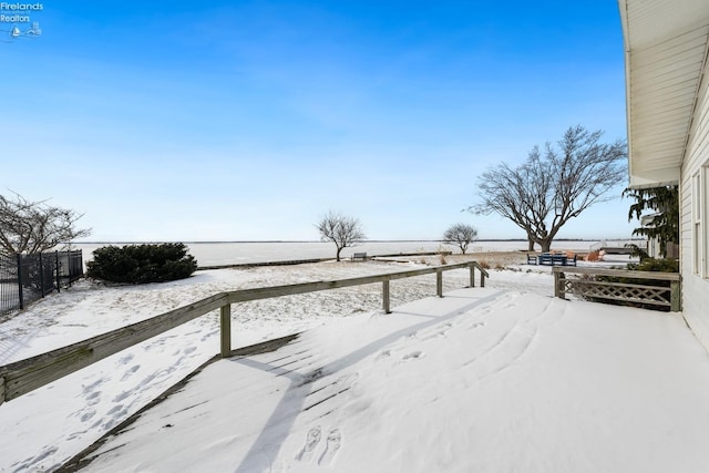 yard covered in snow with fence