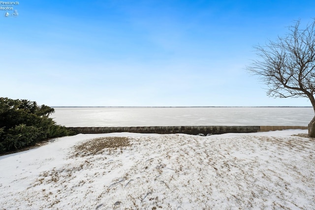 exterior space with a water view and a detached garage