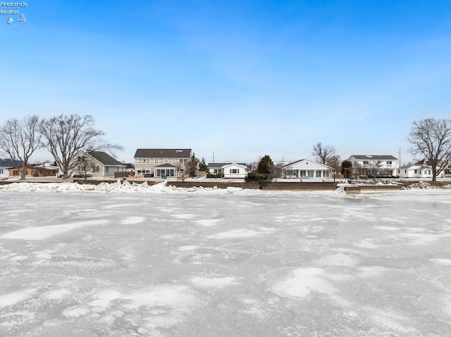 yard covered in snow with a residential view