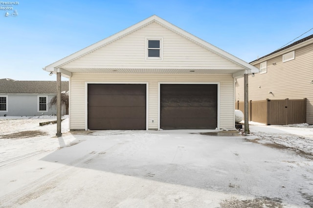 snow covered garage with a garage