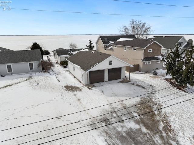 snowy aerial view with a residential view