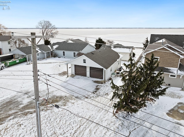 snowy aerial view with a residential view