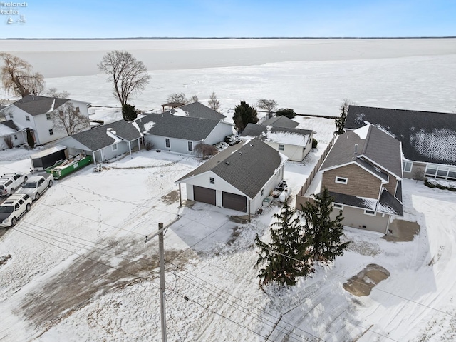 snowy aerial view with a residential view