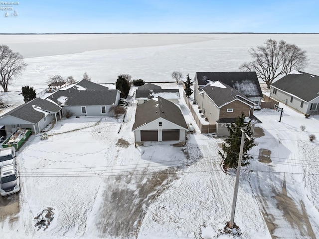 snowy aerial view with a residential view