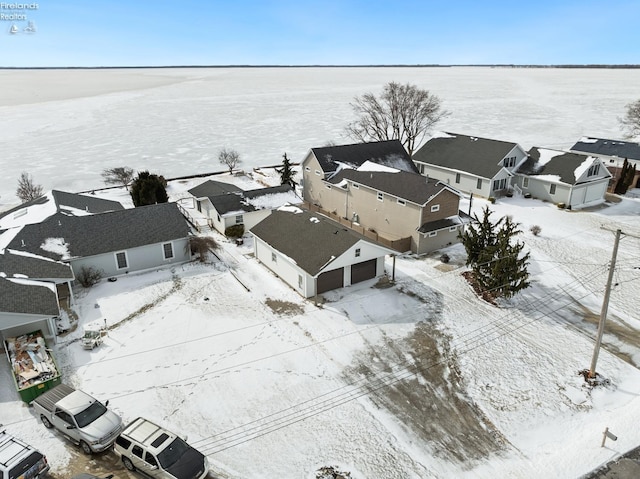 snowy aerial view with a residential view