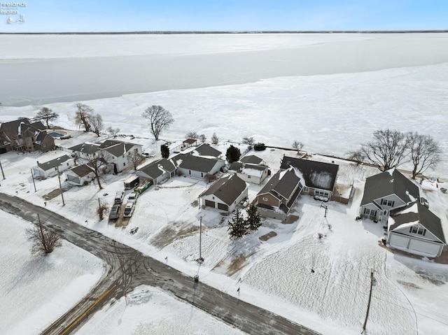 snowy aerial view with a residential view