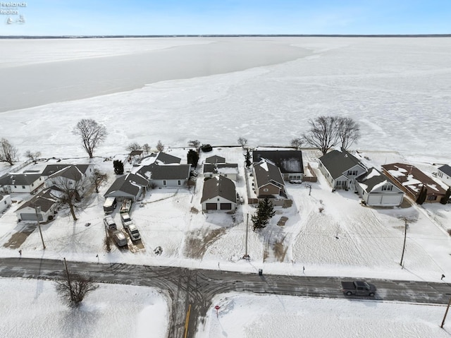 snowy aerial view with a residential view