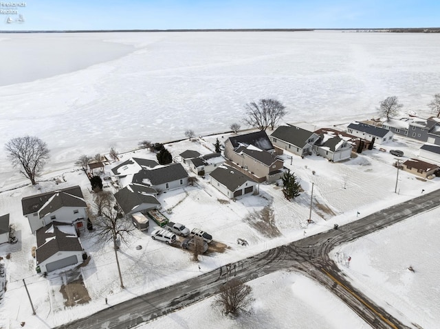 snowy aerial view with a residential view