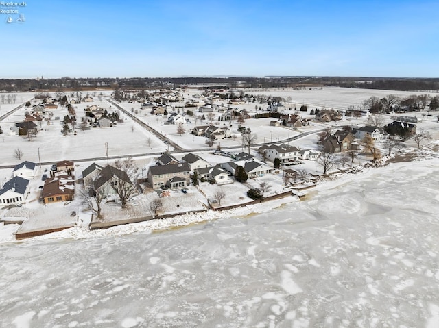 snowy aerial view with a residential view