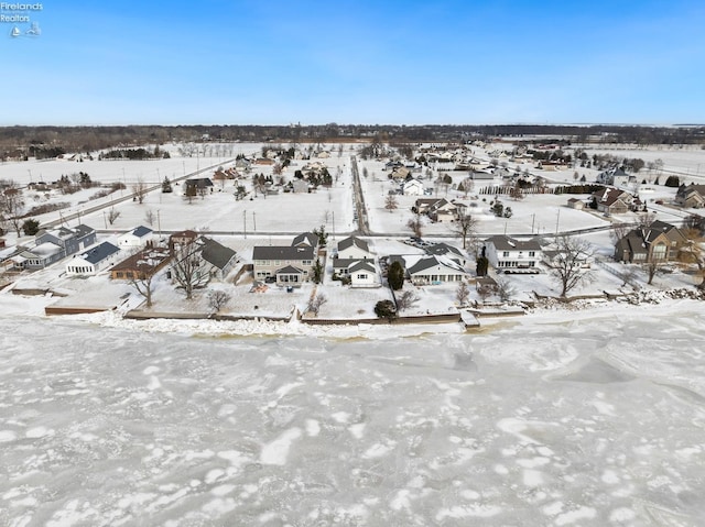 snowy aerial view featuring a residential view