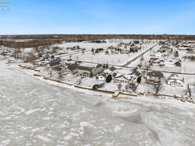 snowy aerial view featuring a residential view