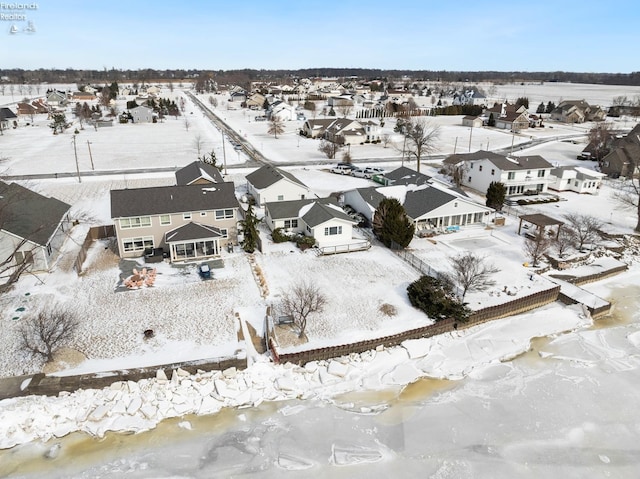 snowy aerial view with a residential view