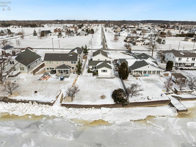 snowy aerial view with a residential view