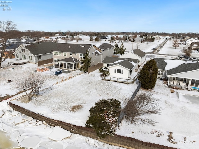 snowy aerial view featuring a residential view