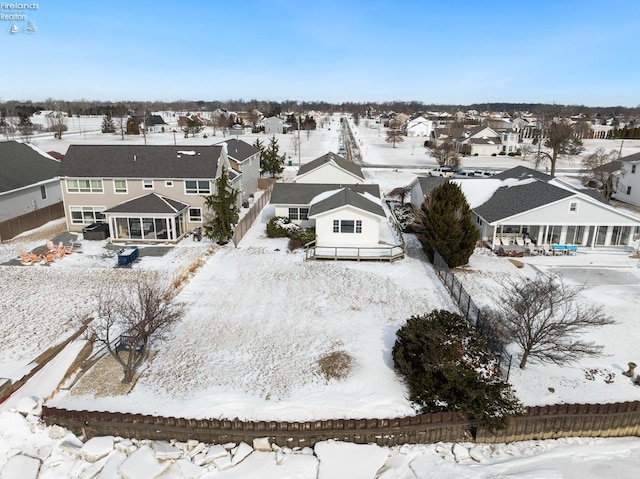 snowy aerial view featuring a residential view