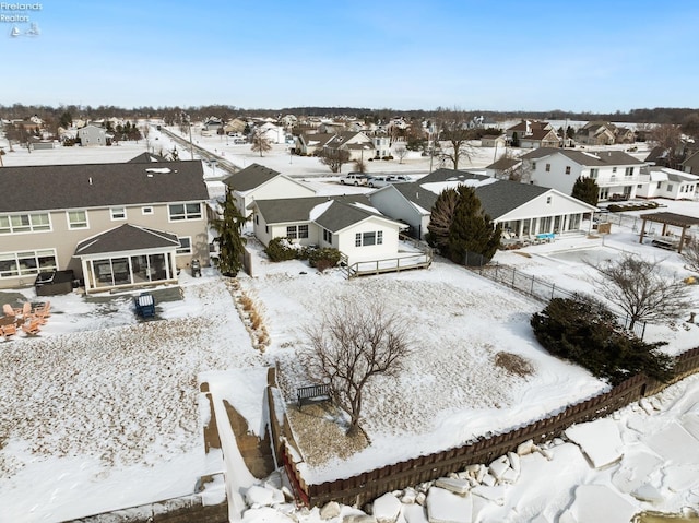 snowy aerial view with a residential view