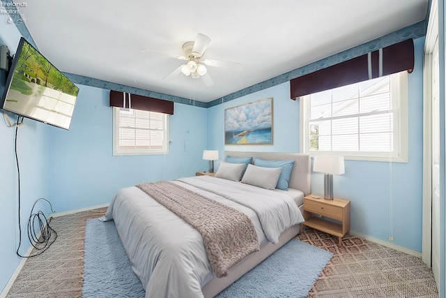 bedroom with carpet, ceiling fan, and baseboards