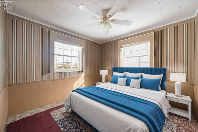 bedroom featuring ceiling fan and ornamental molding