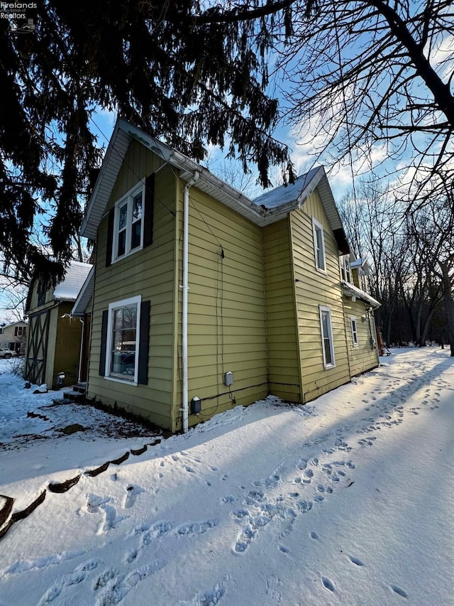 view of snowy exterior with board and batten siding