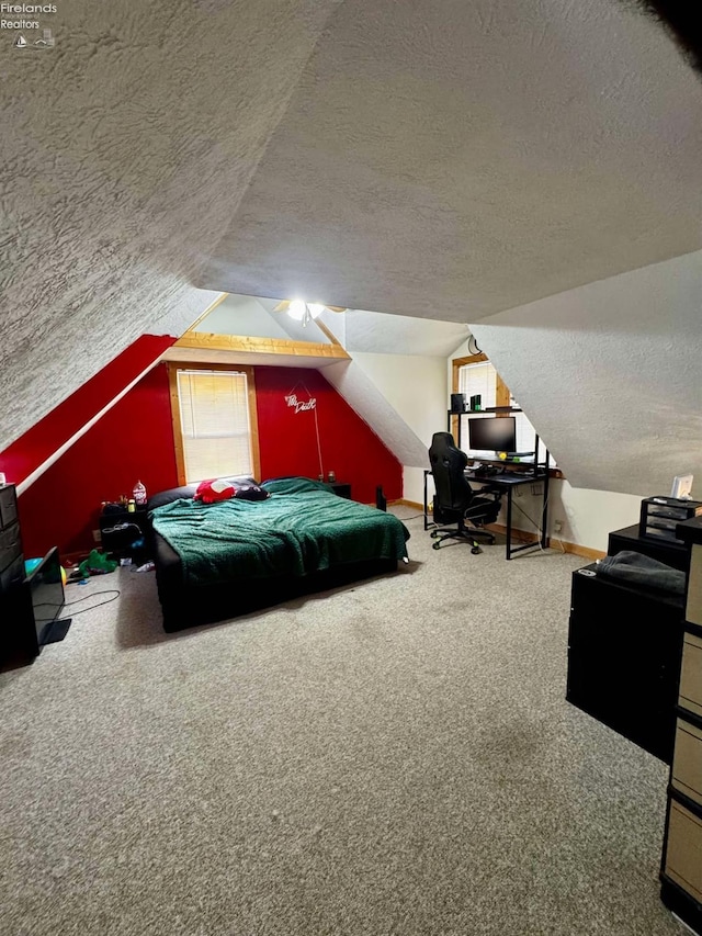 bedroom with carpet floors, baseboards, vaulted ceiling, and a textured ceiling