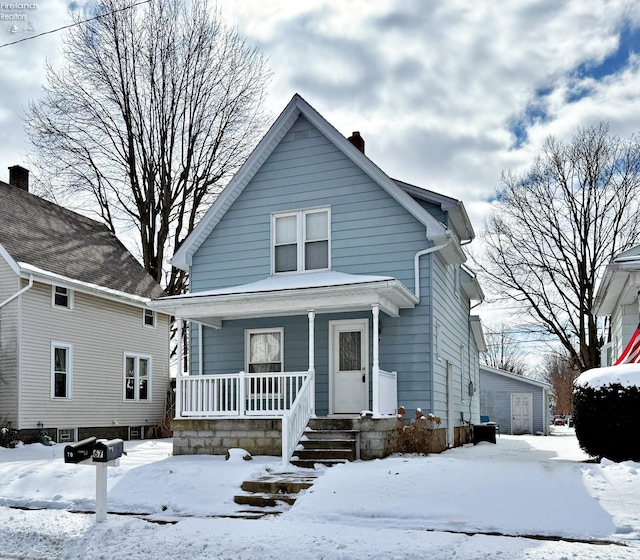 bungalow-style home with a chimney and a porch