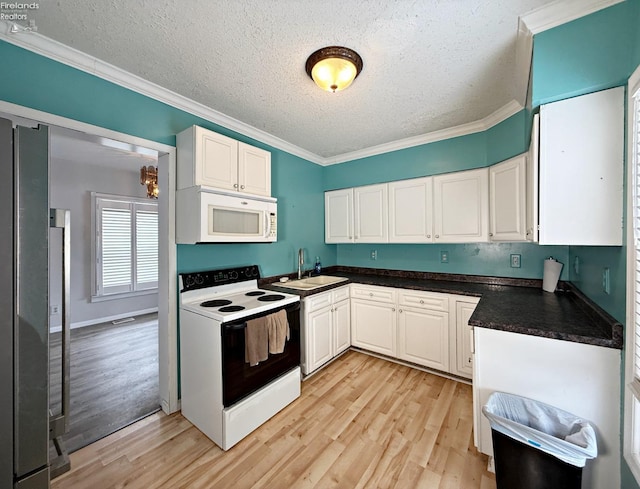 kitchen featuring white appliances, a sink, white cabinetry, and crown molding