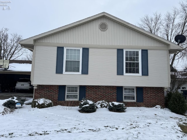 view of front of property with a garage and brick siding